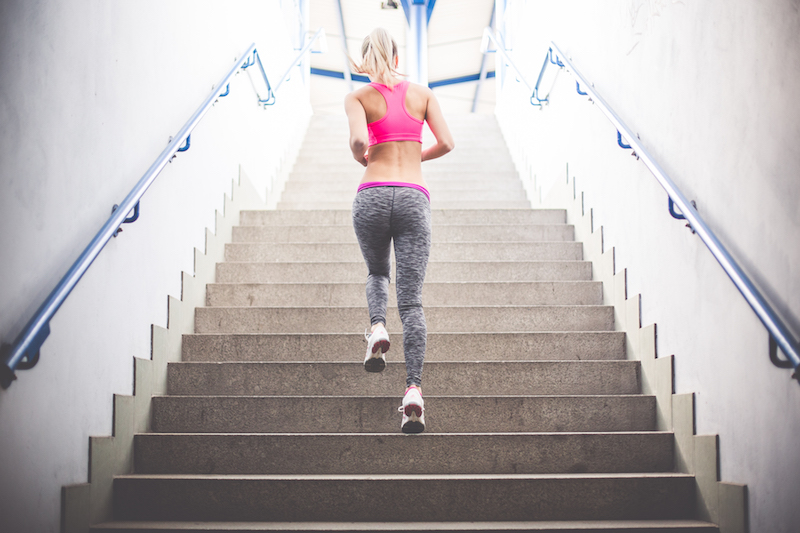 Young fitness girl running up the stairs picjumbo com